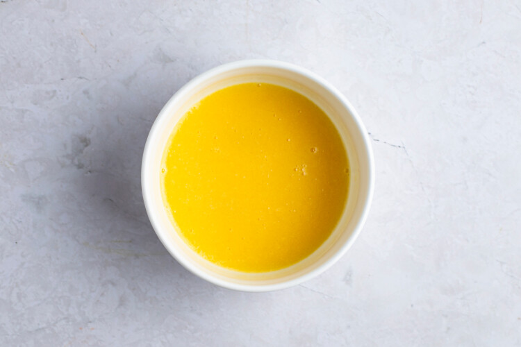 Melted butter with egg in ramekin