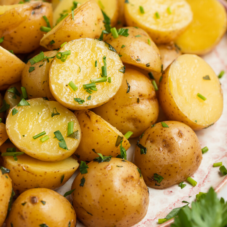 sous vide potatoes on a plate with fresh parsley on the side