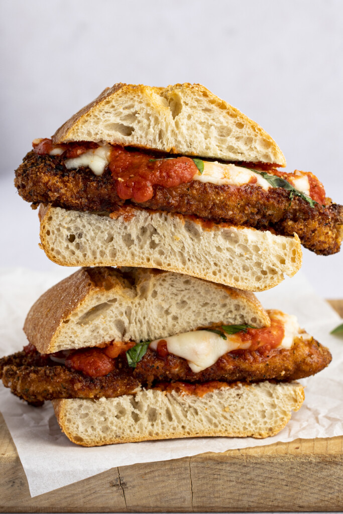 Two chicken parm sandwiches stacked on top of each other