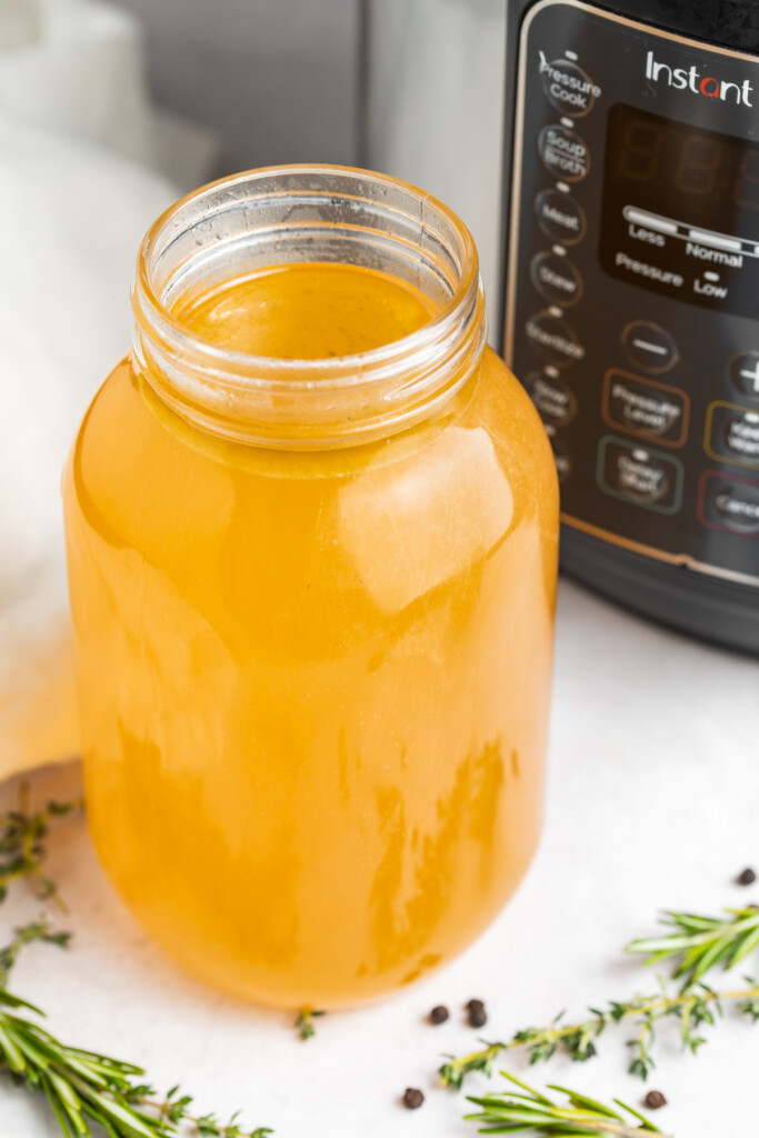 instant pot turkey stock in a jar in front of the instant pot