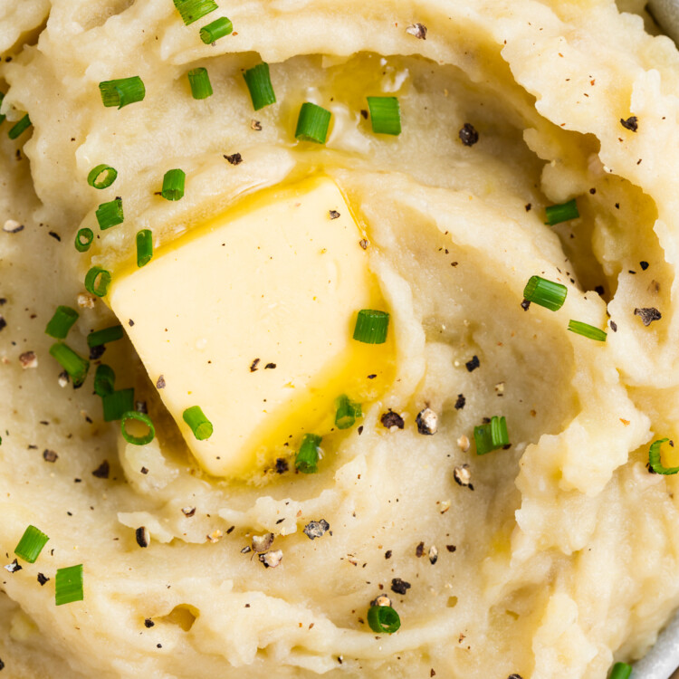 overhead image of sous vide mashed potatoes in a bowl with butter and chives
