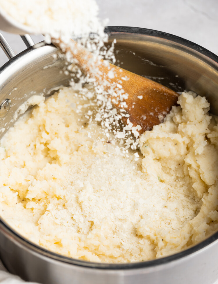 Dehydrated potatoes being poured into a pot of mashed potatoes