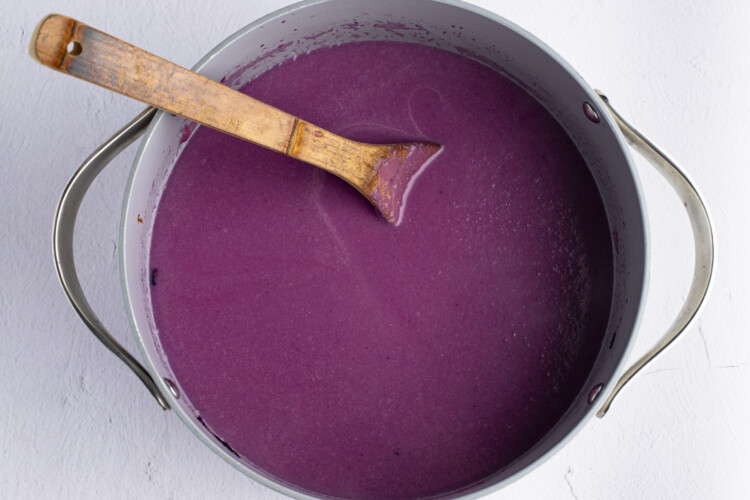 Puréed red cabbage soup in large pot with wooden spoon