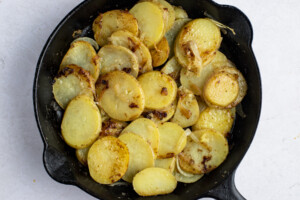 Smothered potatoes in cast iron skillet