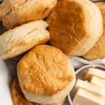 air fryer frozen biscuits in a basket with butter