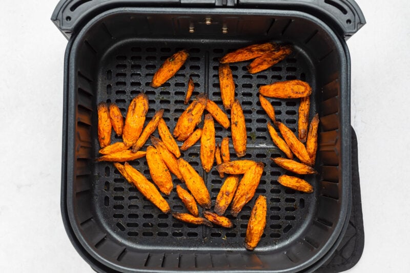 Air fryer carrots in an air fryer basket.