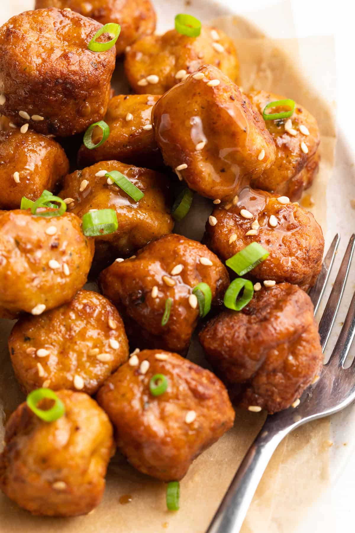 frozen meatballs in air fryer on a plate with a fork
