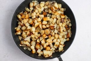 Pan-fried potatoes and onions in large cast iron skillet