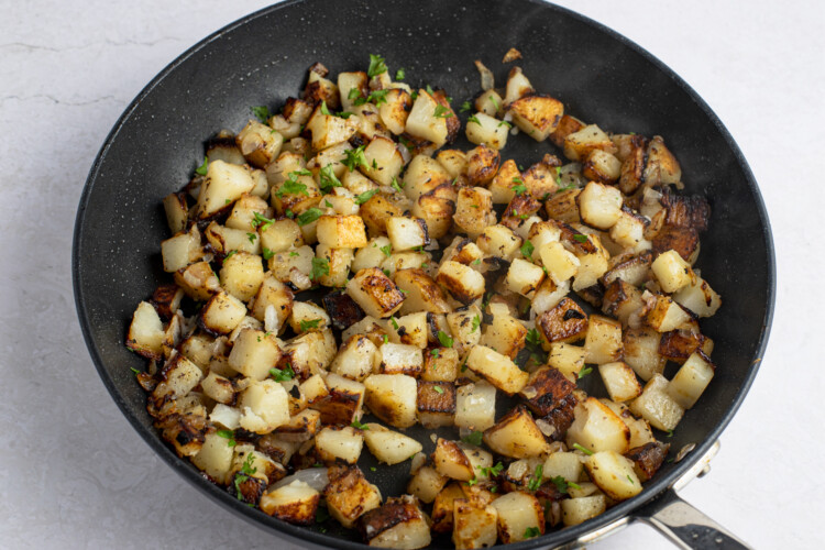 Pan-fried potatoes and onions in large cast iron skillet