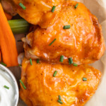 close up image of buffalo chicken thighs on a plate