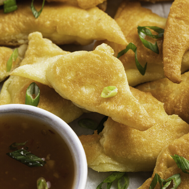 Keto crab rangoon on a plate with apricot preserves