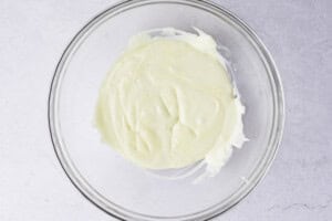 Melted mozzarella cheese in large glass mixing bowl
