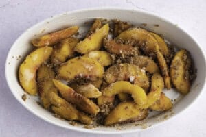 Keto peach filling in a large white oval baking dish.
