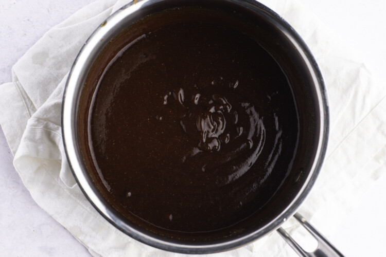 Overhead, close-up view of vegan bbq sauce in a silver saucepan.