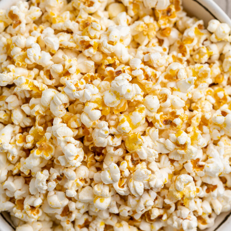 Overhead, close-up view of a large bowl of vegan buttery popcorn.