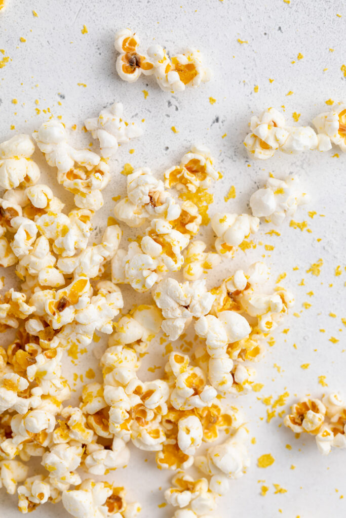 Popcorn scattered on a white background.