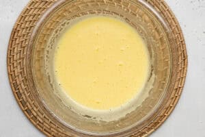 Overhead view of ingredients for keto lemon curd in a large glass bowl.