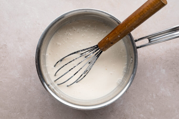 Sugar and cornstarch in small saucepan with wooden-handled whisk.