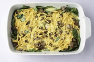 Overhead view of an unbaked keto breakfast casserole in a casserole dish.