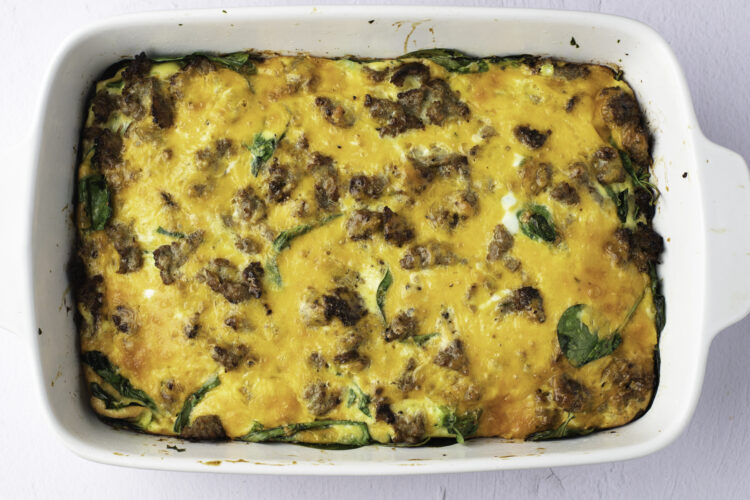 Overhead view of a fully-baked keto breakfast casserole in a white casserole dish.