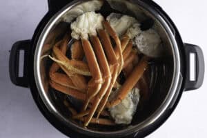 Overhead view of snow crab leg clusters in Instant Pot.