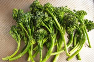 Trimmed broccolini on a cutting board.