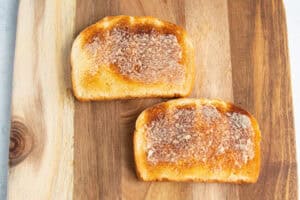 Buttered toast on a cutting board.