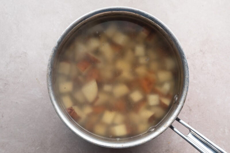 Overhead view of cubed red skin potatoes in a pot of boiling water.