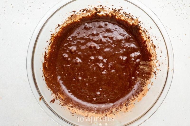 Brownie batter in a large glass mixing bowl.