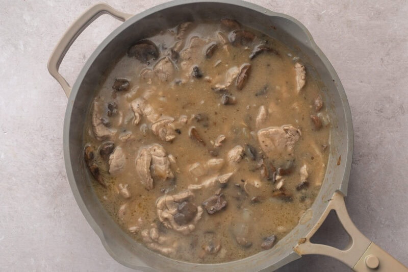 Browned strips of pork tenderloin in large skillet with sauteed mushrooms and onions, dry sherry, and beef broth.