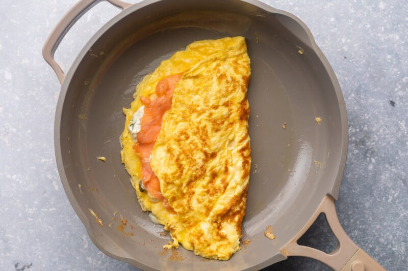 Folded salmon omelette in a large skillet.