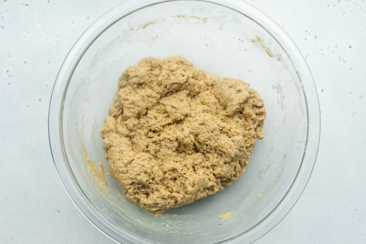 Seitan "dough" for vegan chicken sandwiches in a large glass mixing bowl.