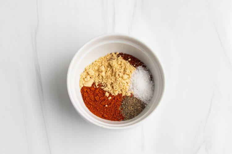 Dry rub spice blend ingredients in medium white bowl.
