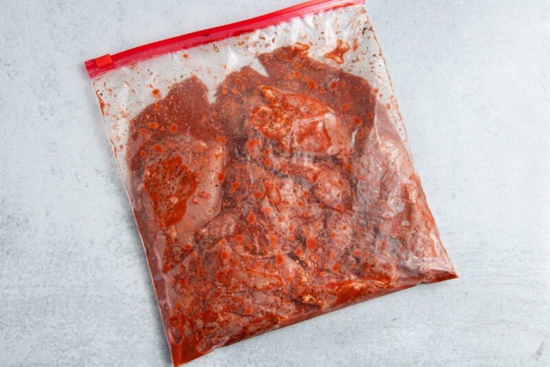 Chicken thighs and achiote marinade in large zippered plastic bag.