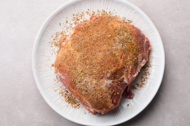 2 pound pork shoulder coated in spice rub.