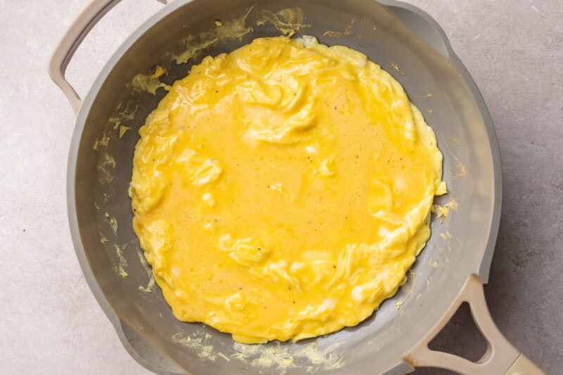 Scrambled eggs for a chicken omelette in a medium non-stick skillet.