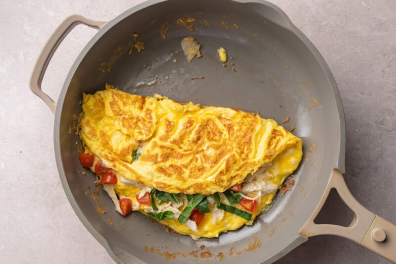 Folded chicken omelette in a medium non-stick skillet.