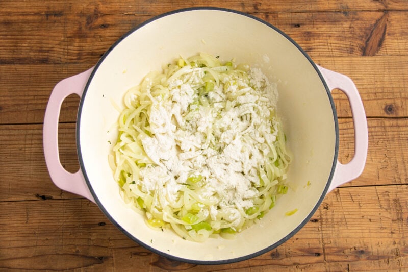 Onions and celery in a large pot with minced garlic and thyme.
