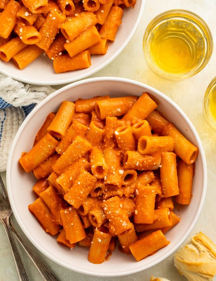 Two white bowls of rigatoni alla vodka.