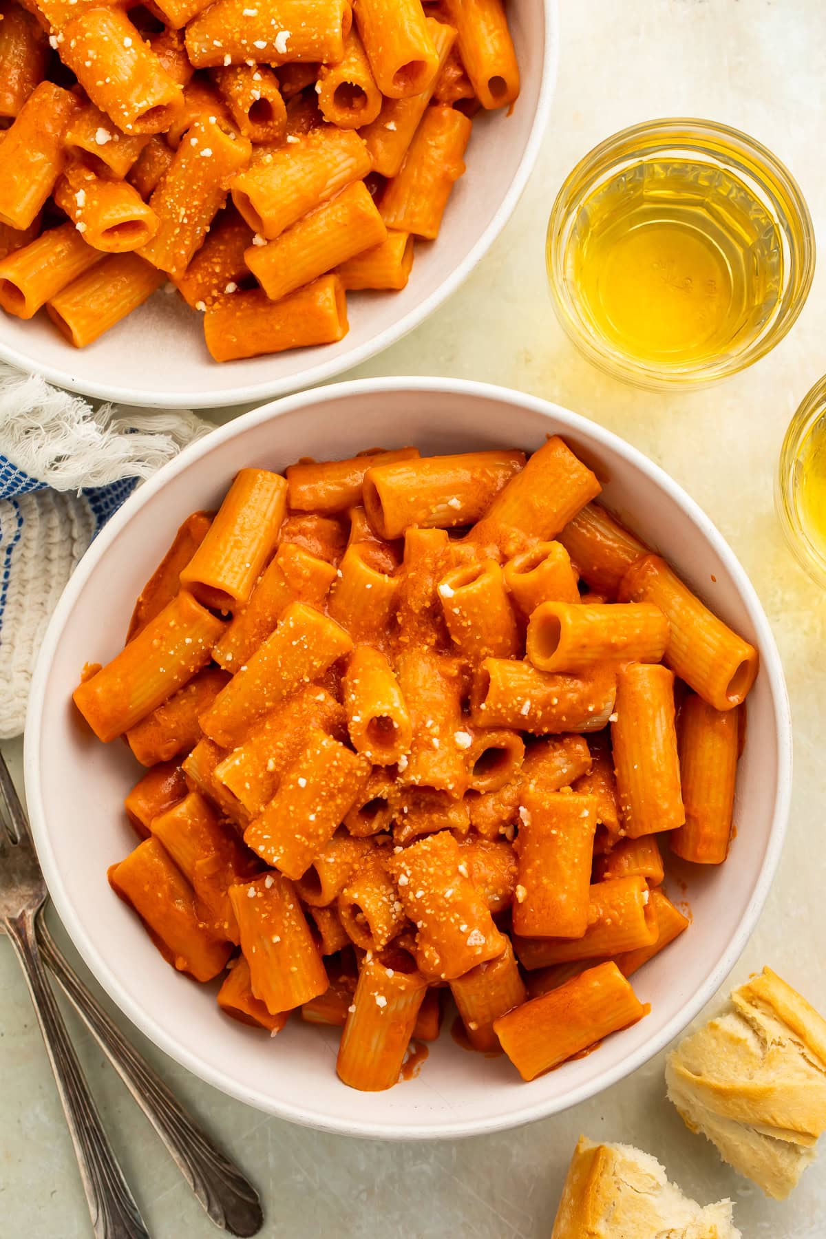 Two white bowls of rigatoni alla vodka.
