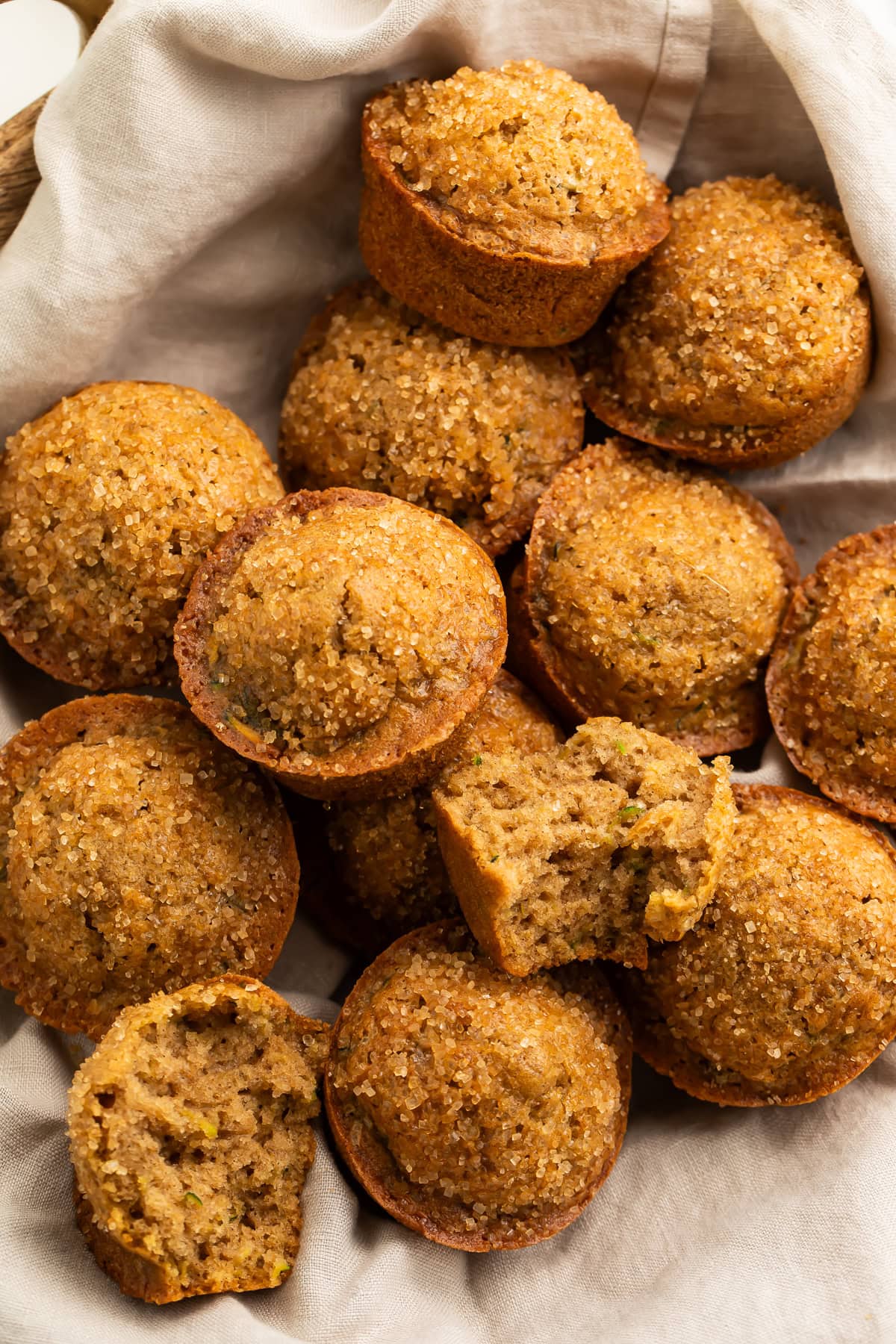 Linen-lined basket of gluten-free zucchini muffins. 