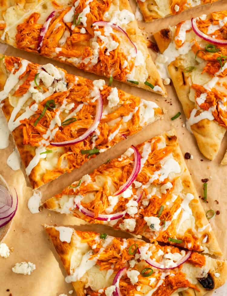 Close up of buffalo chicken flatbread cut into triangles.