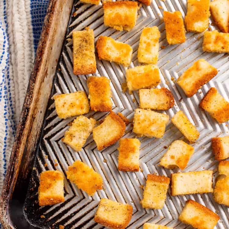Close up of croutons on a baking sheet.