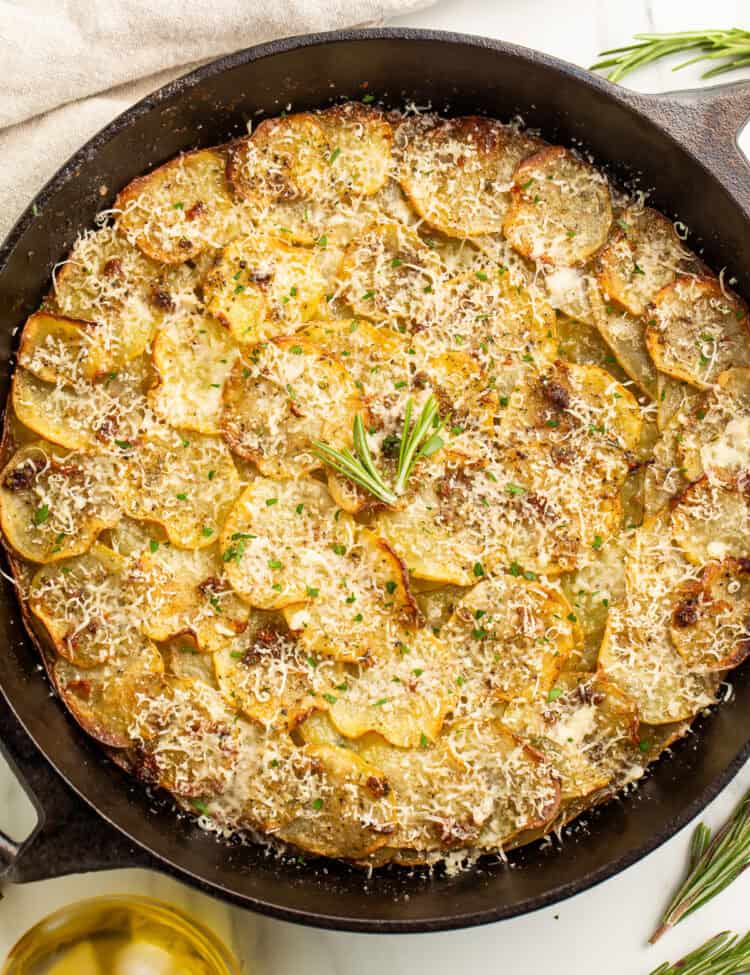 Overhead image of a potato galette in a cast iron skillet.