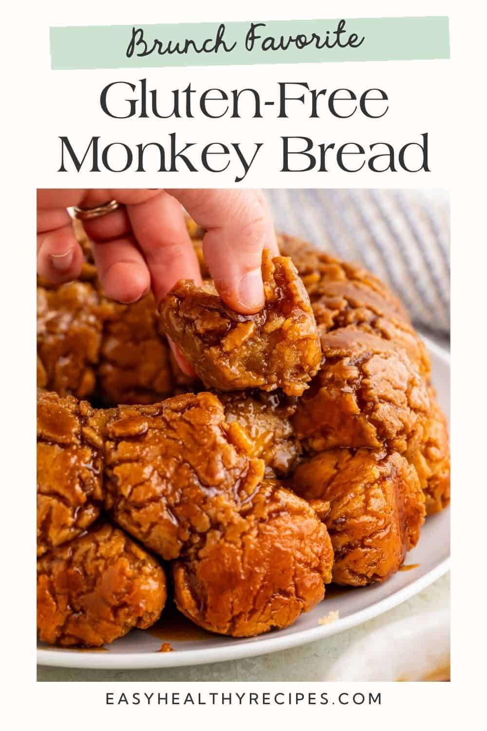 Close up of a hand picking up a piece of monkey bread.