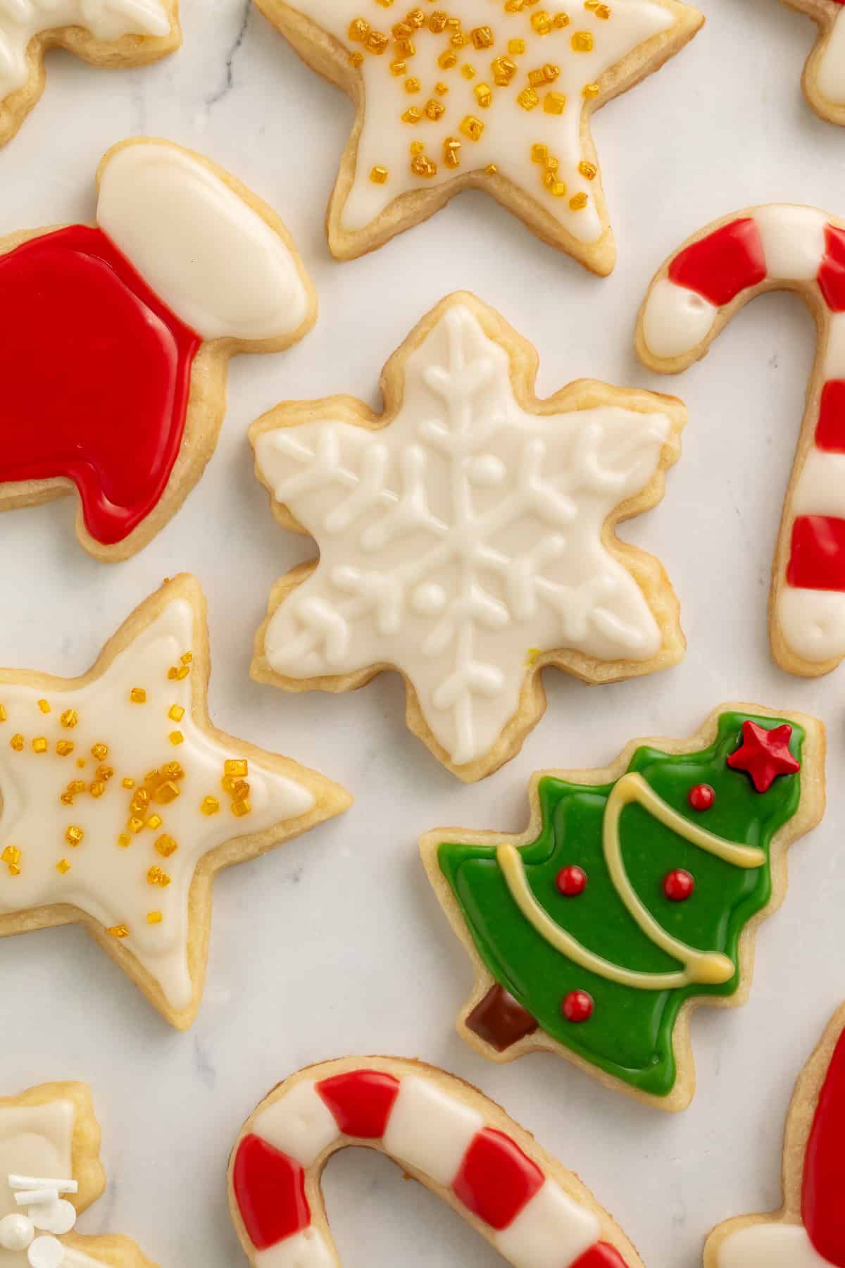 Decorated Christmas cookies with snowflakes, stars, gloves, Christmas trees and candy canes.