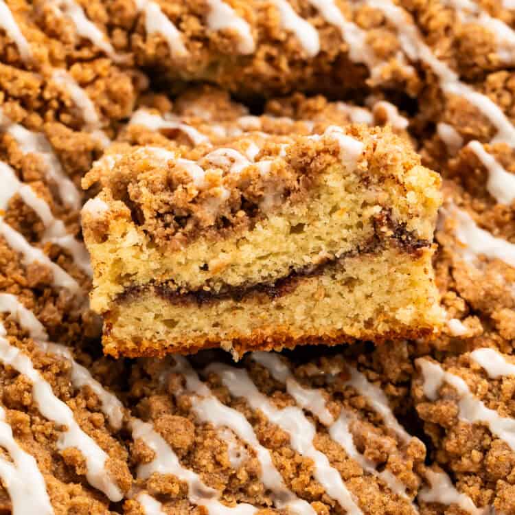 Close up of a piece taken out of a coffee cake to show the swirl in the middle.