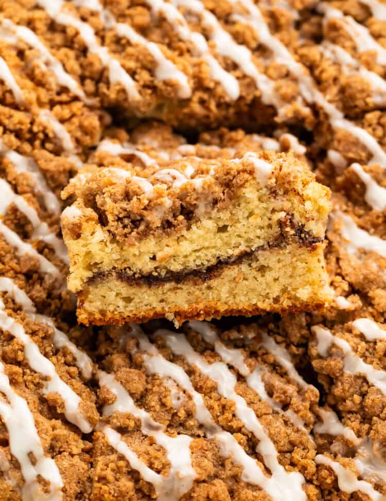 Close up of a piece taken out of a coffee cake to show the swirl in the middle.