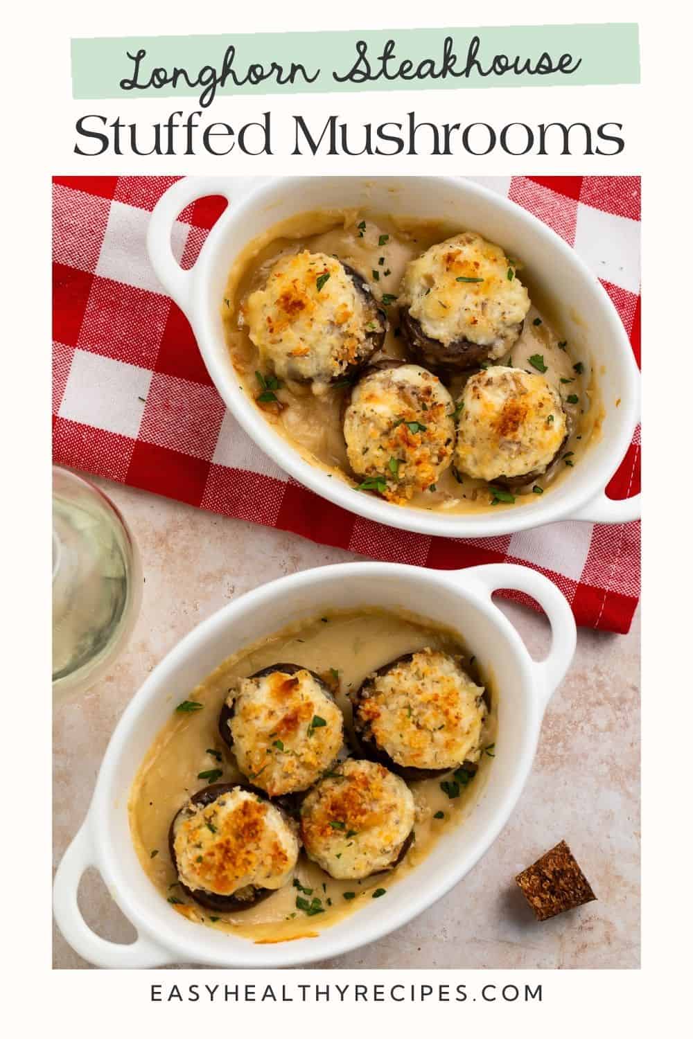 Two white fishes of baked stuffed mushrooms on a folded red and white gingham table cloth. There is a white frame on the image with a Pinterest-optimised text overlay.