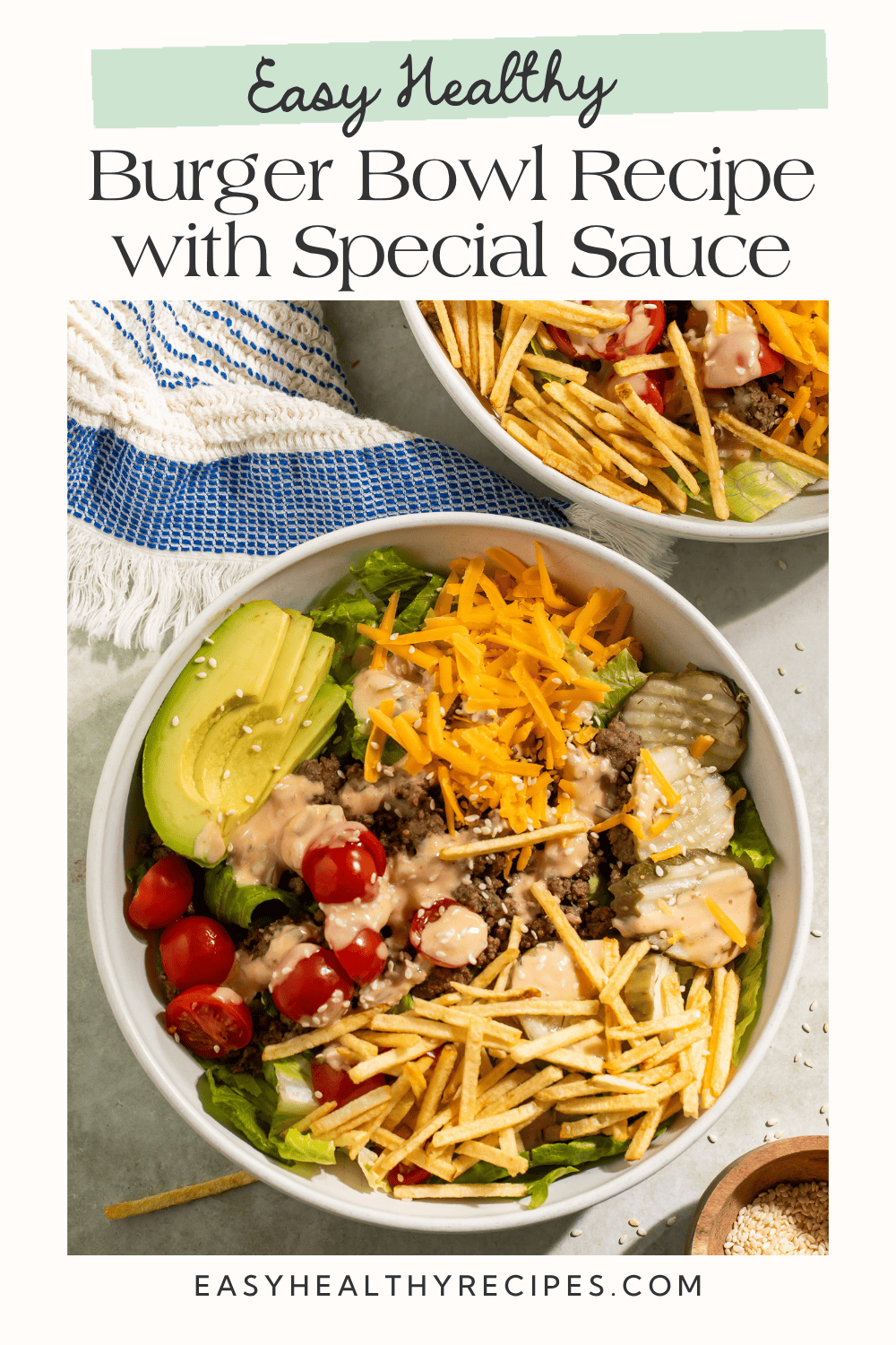 Overhead view of burger bowl with ground beef, romaine, avocado, cheddar, tomatoes, and special sauce